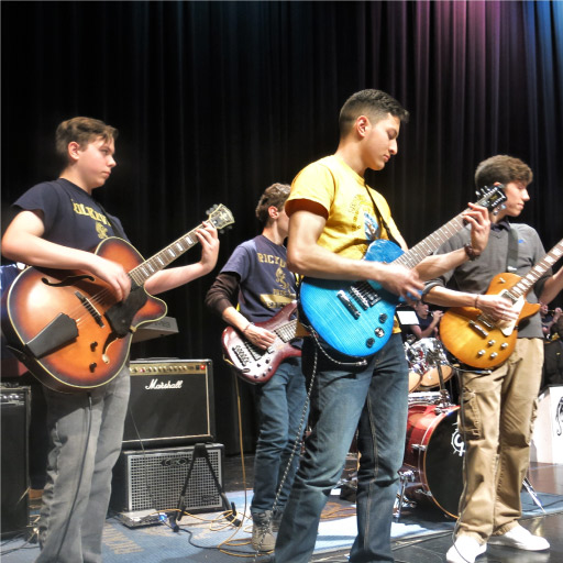 RNA-students-playing-guitar-on-stage